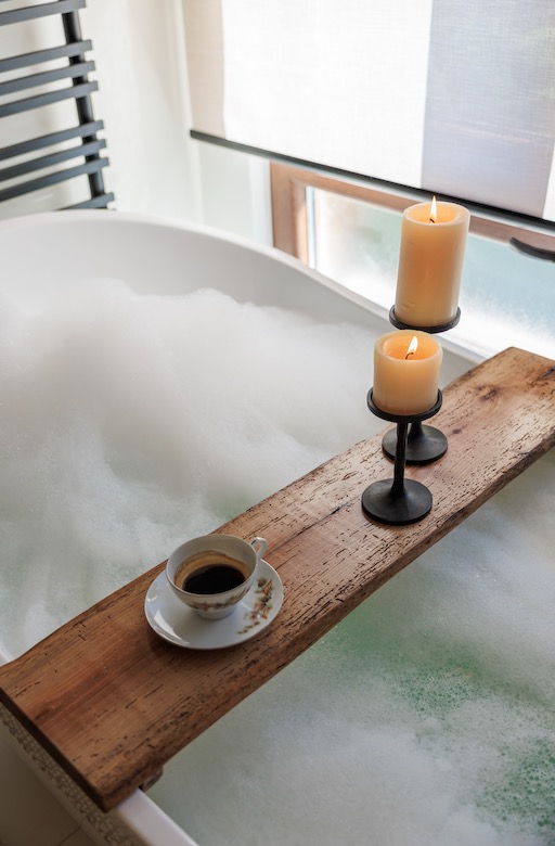 Un rituale serale all'Hillside Lodge — il calore del bagno, le candele e la serenità totale.